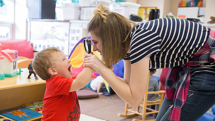 Missouri State student interacting with kid at Child Development Center