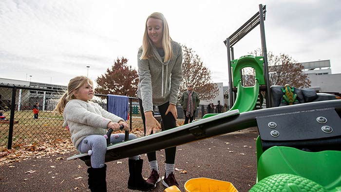 Missouri State student working with kid outside at Child Development Center