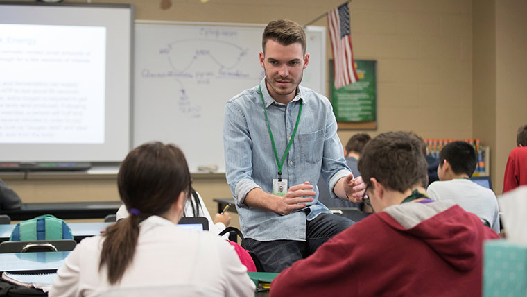 A biology education major talking to students in class during his practicum at a local high school.