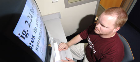 Student reading computer screen