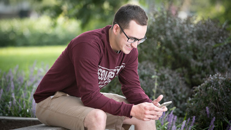 Student in BearWear using phone.
