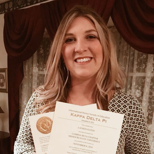 Lauren Floyd holding up a scholarship award letter