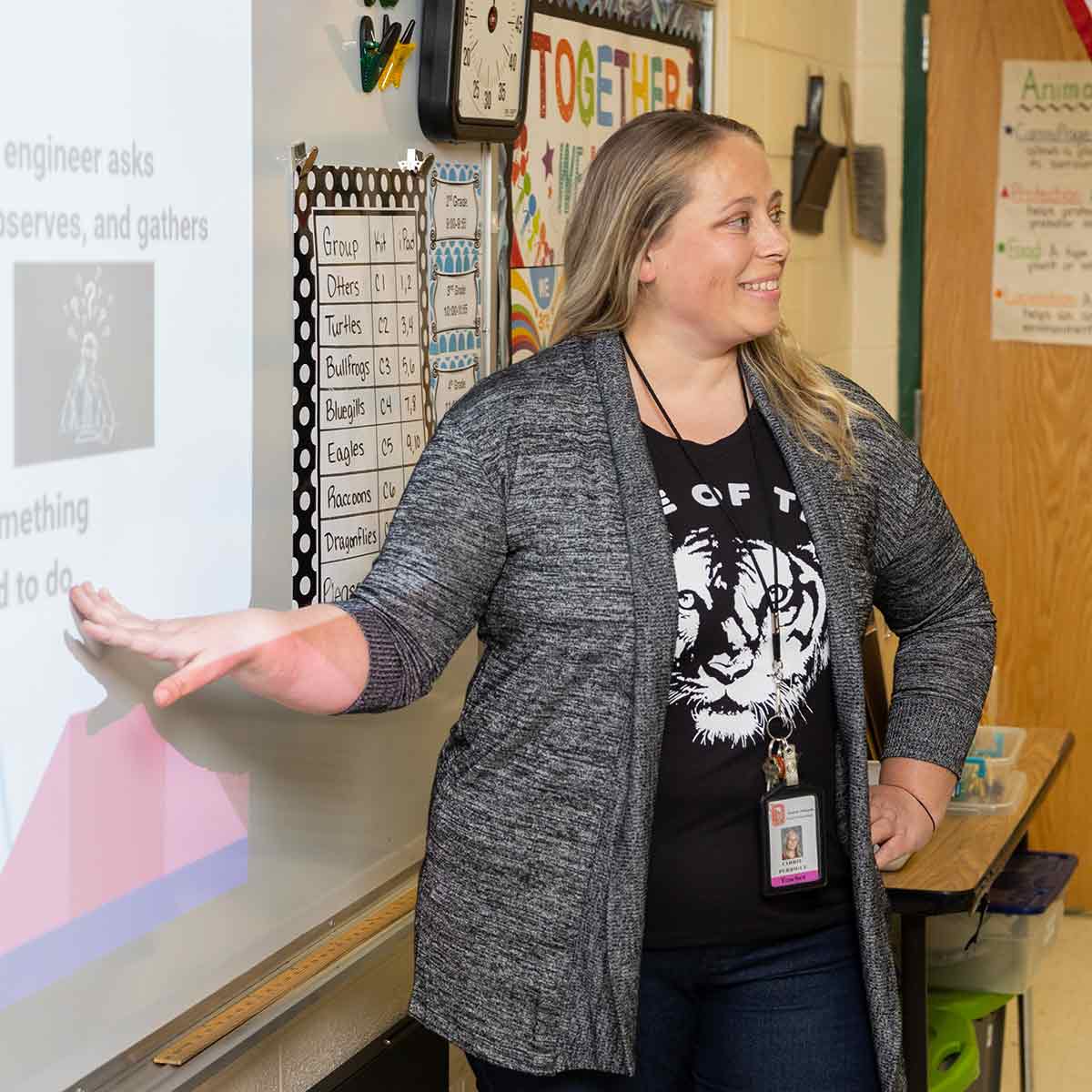 An elementary school teacher giving a presentation in class.