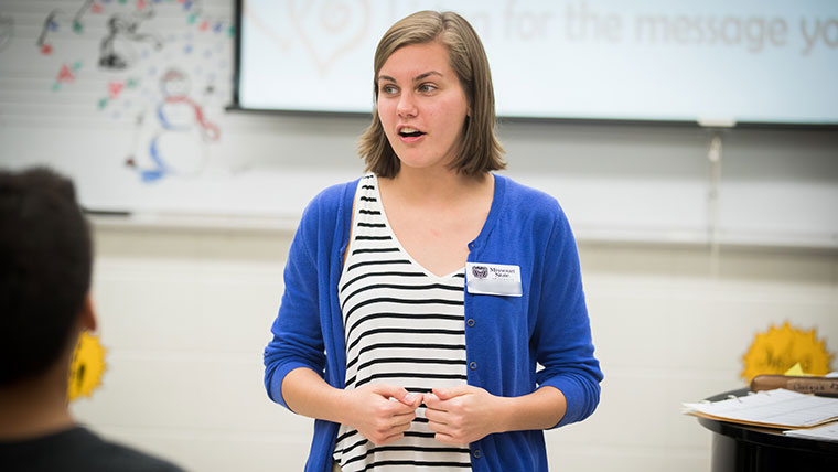 A music teacher speaks to her class.