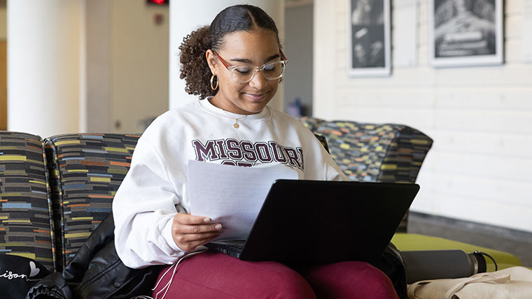 A happy student studying in Meyer Library.