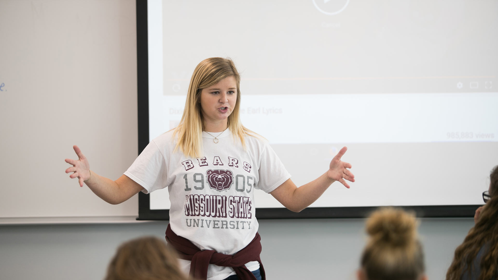 A Missouri State education student instructs middle school students in class during a campus visit.