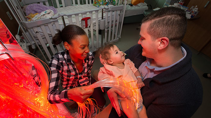 Child life specialists helping patient in hospital