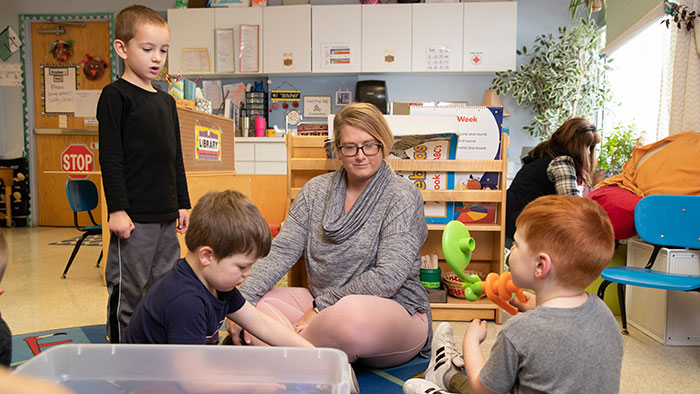 Student working with kids at child development center