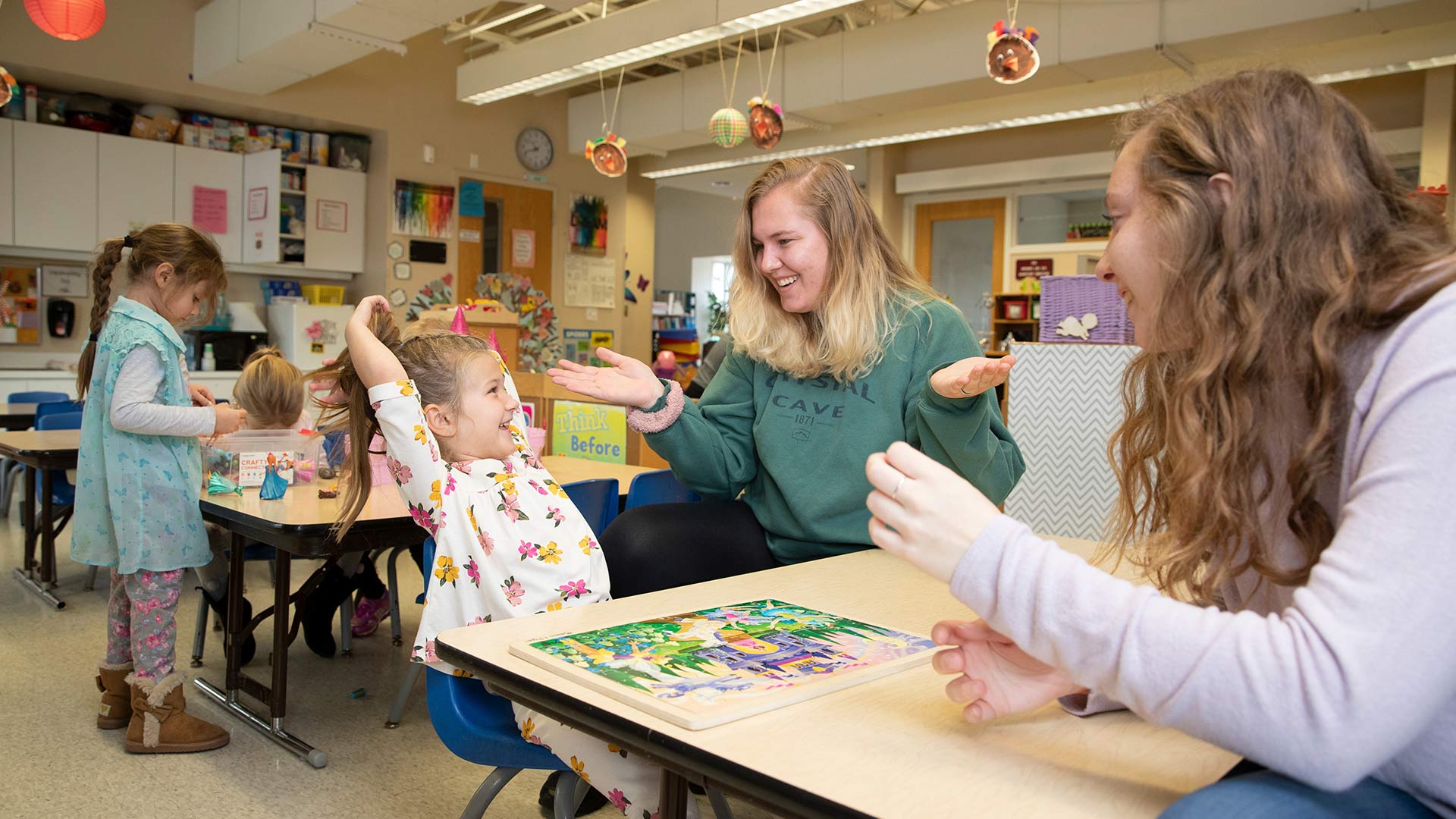 Missouri State students working with young child inside Child Development Center.