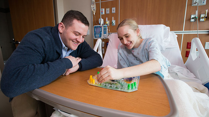 Child life student working with hospitalized kid