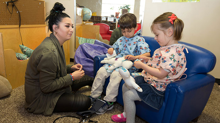 Student working with kids at child development center