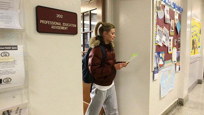 Student walking out of Education Advisement office