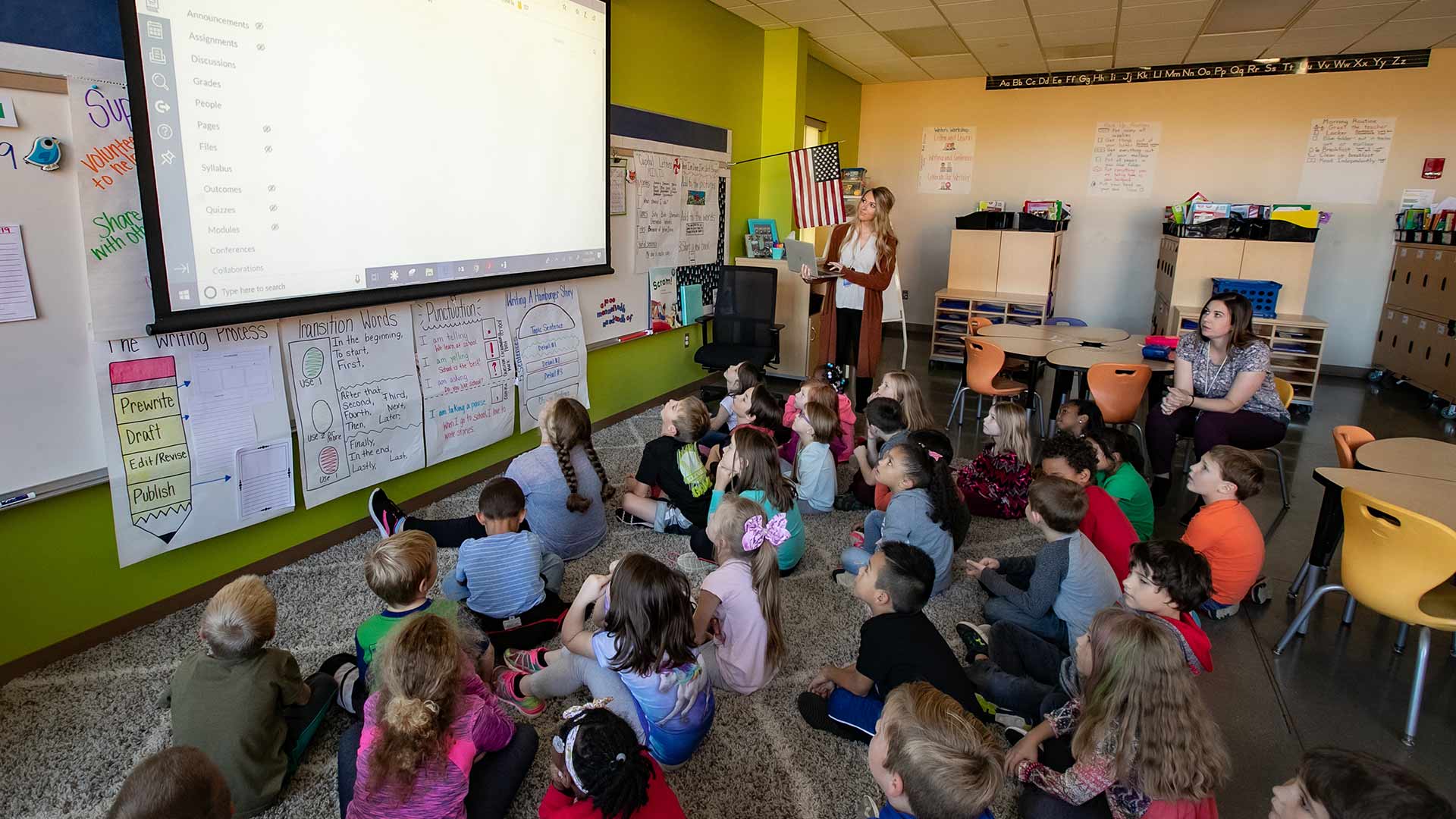 Alumnae Jessica Ridder and Laura Snelson teaching students at Sherwood Elementary