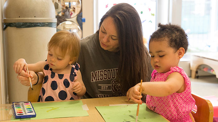 Instructor working with kids at child development center