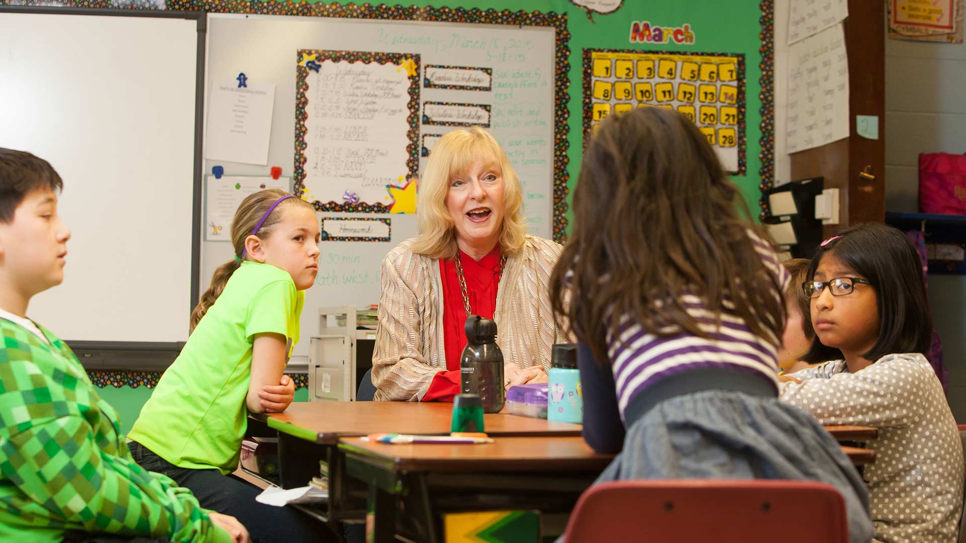 Teacher talking to elementary students