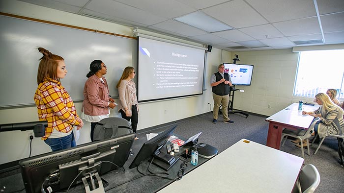 Elementary education students making classroom presentation