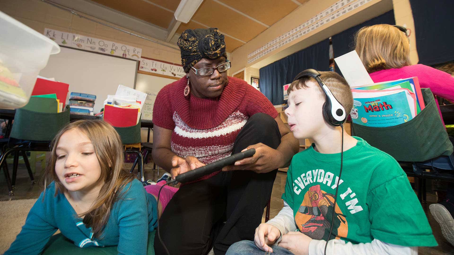 Elementary teacher working with students in classroom