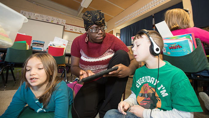 Elementary teacher working with students in classroom