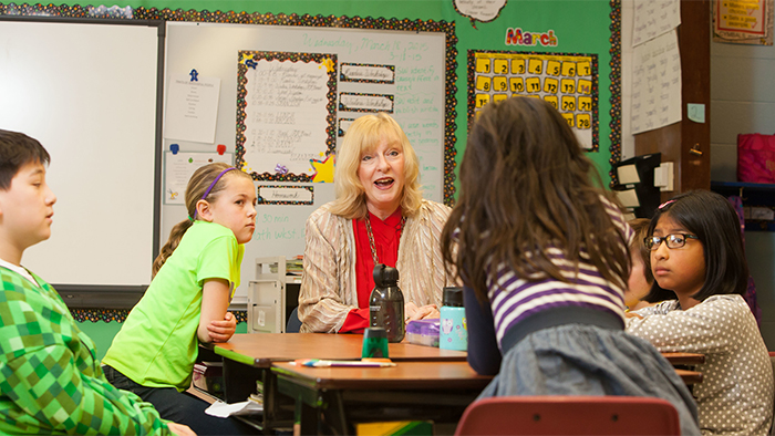 Teacher talking to elementary students