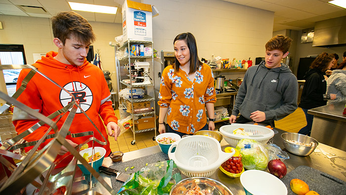 Student teacher instructing high school students