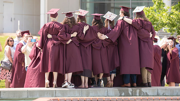 Graduates posing for commencement photos