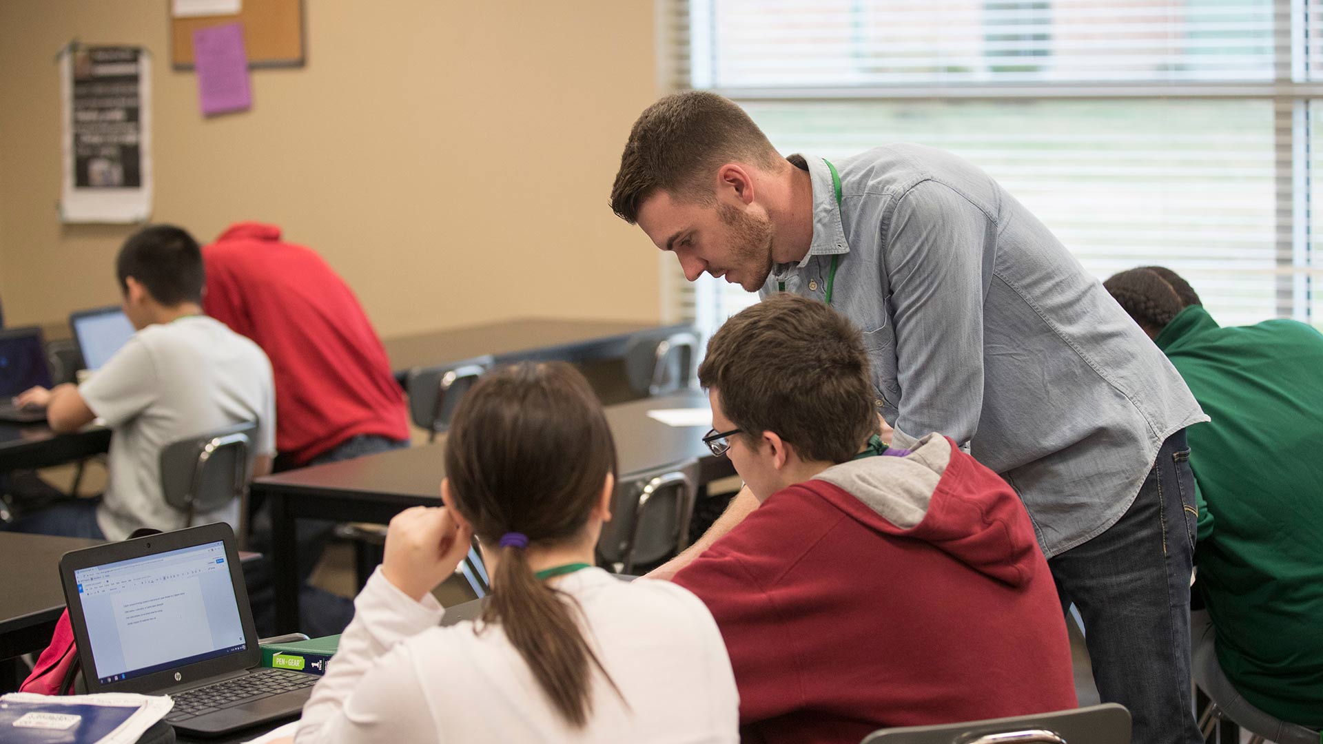 Student teacher working with students in high school classroom.