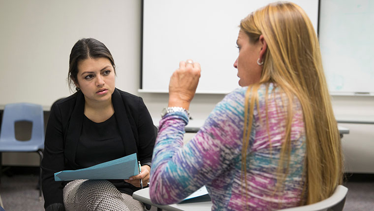 Education student having group discussion in class.