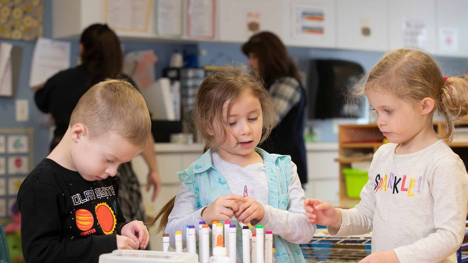 Three children working together.