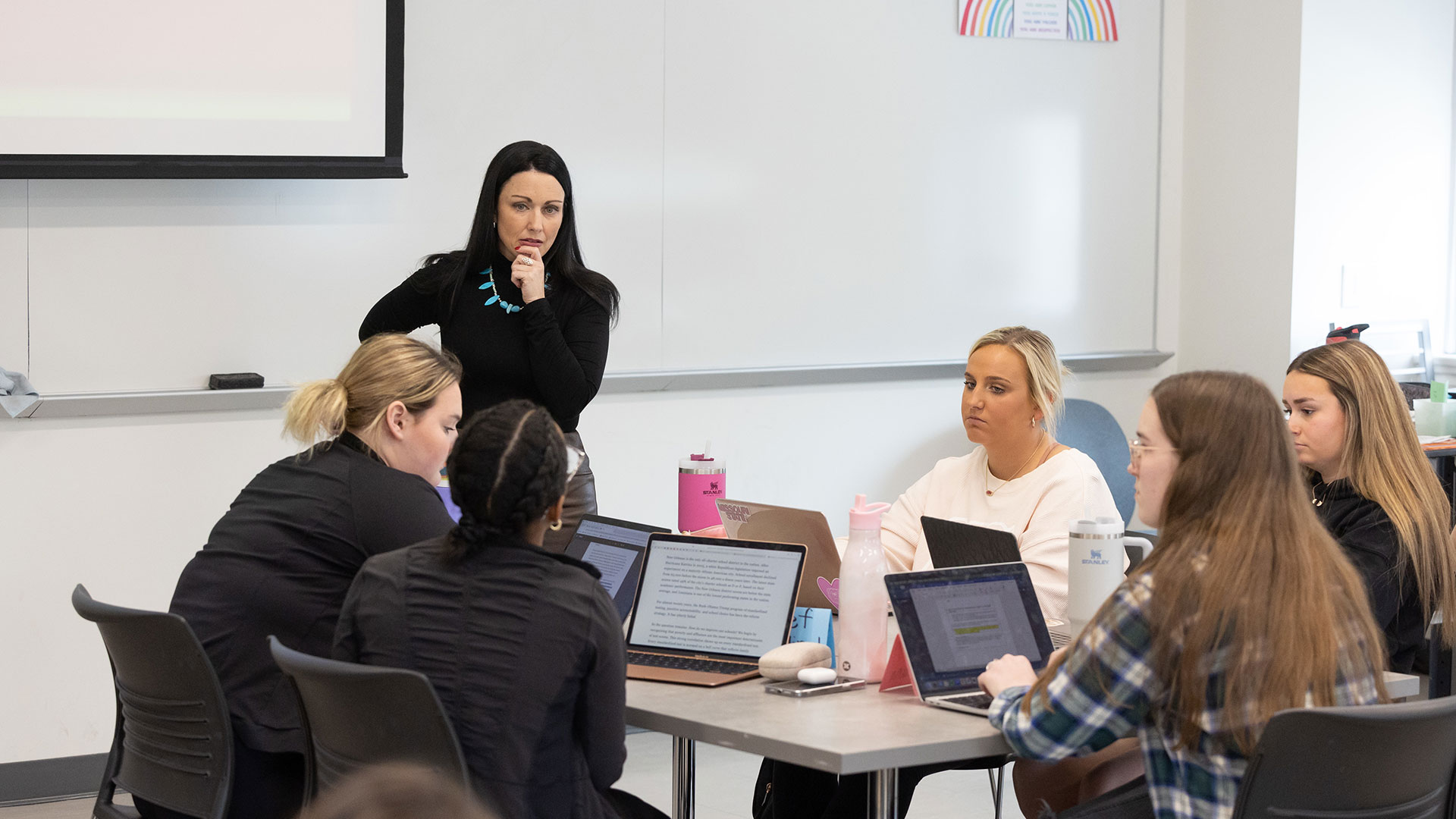 Dr. Kayla Lewis, professor of reading, foundations and technology, listens to her student in her Foundations of Literacy and Instruction class.