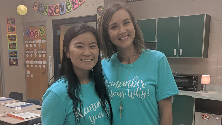 An Internship Academy student with her master teacher in an elementary school classroom.